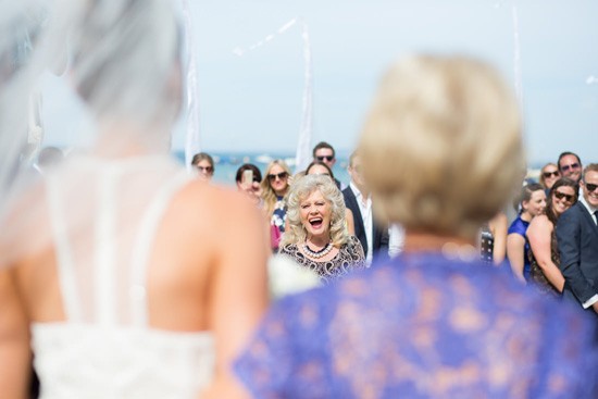 Expression of guests at bride walks down the aisle