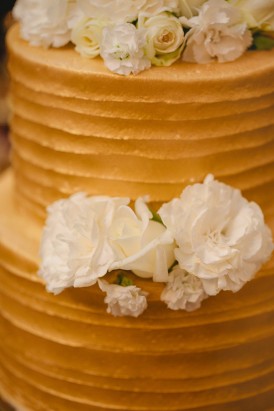 Gold wedding cake with white flowers