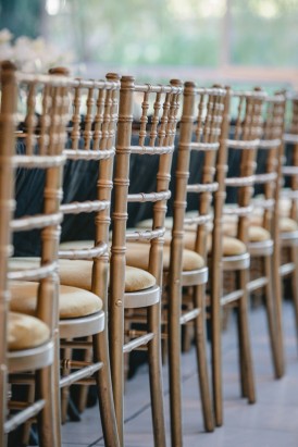 Golden chivari chairs at wedding
