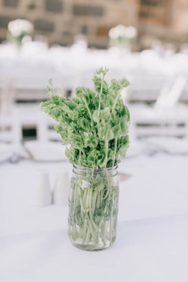 Greenery in glass jar at wedding