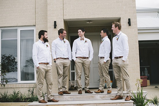 Groom and groomsmen in white shirts with khaki pants