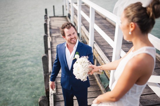 Groom in navy suit with white shirt