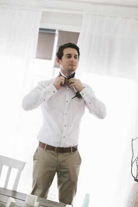 Groom in taupe pants and white shirt