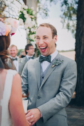 Groom laughing during ceremony