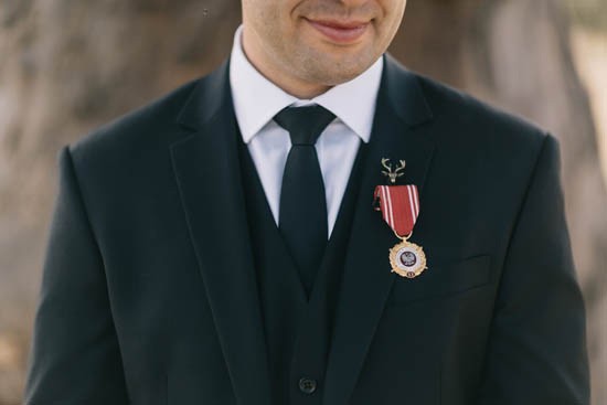 Groom with black suit and war medals