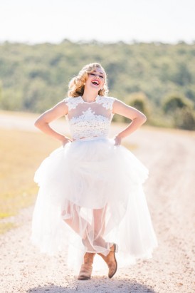 Laughing bride with tulle wedding dress and boots
