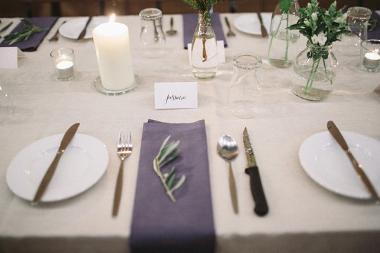Navy napkin at wedding with olive leaf