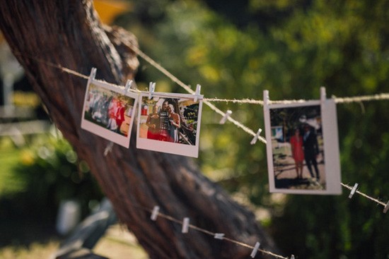 Poloroids hanging with pegs at wedding