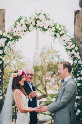 Wedding ceremony under rose flower arch