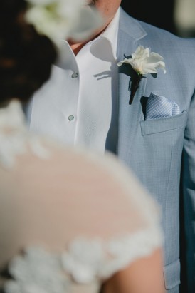 White boutonerrie on grey suit