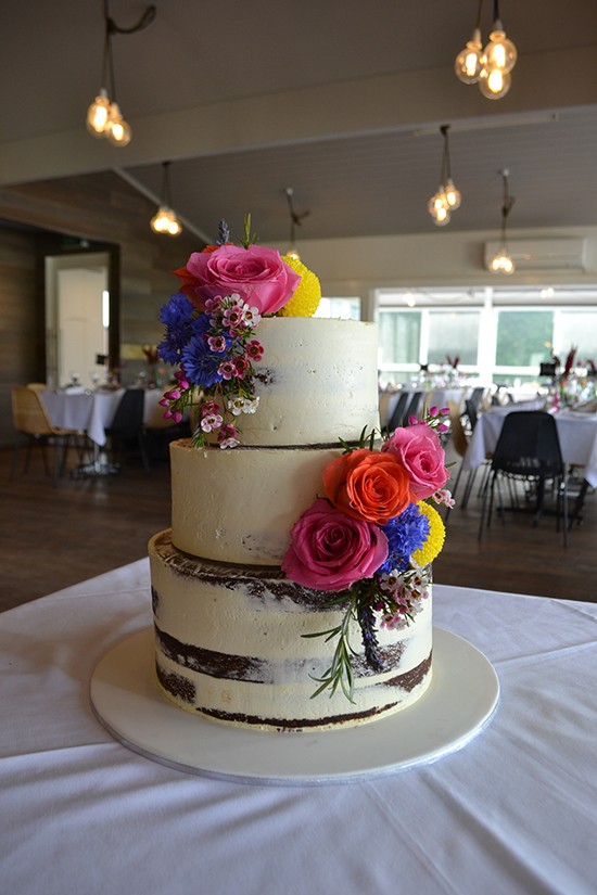 Naked Wedding Cake With Bright Flowers