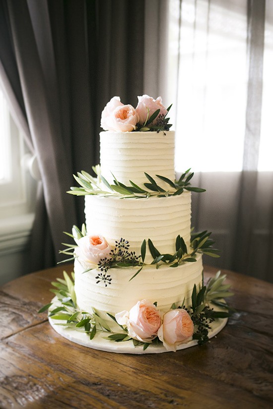 Wedding cake with olive leaves and peach roses