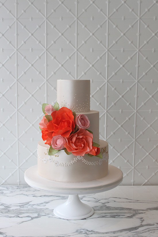 White wedding cake with orange flowers
