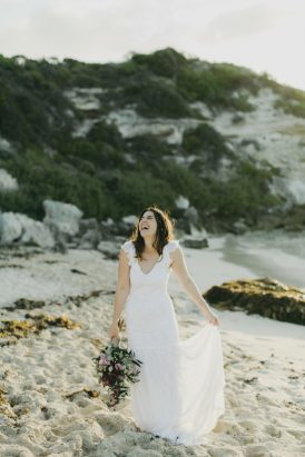 bride-laughing-on-beach
