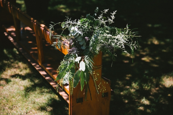 greenery-on-pew-end-at-wedding